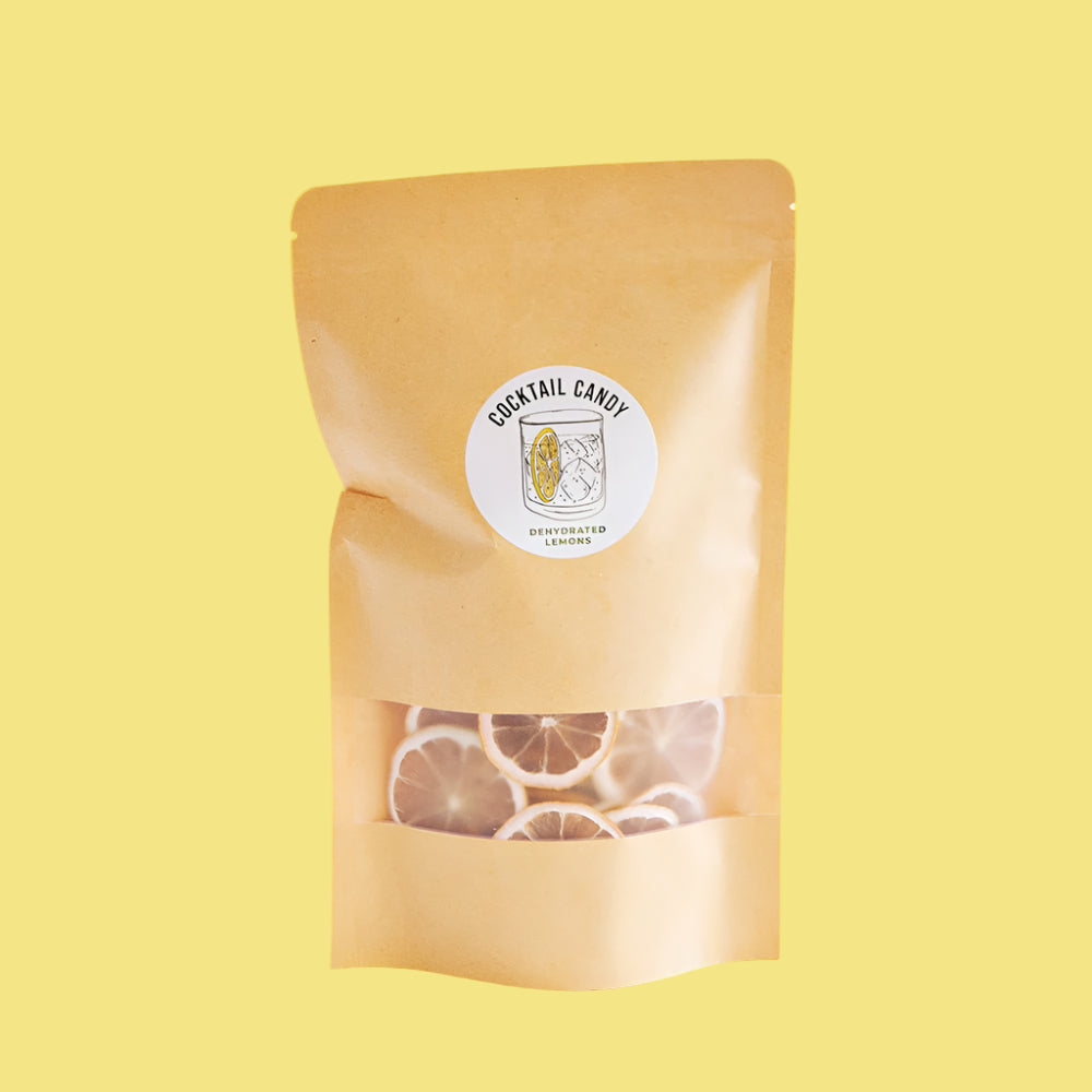 Beige packaging of cocktail candy with a visible brand label on a yellow background