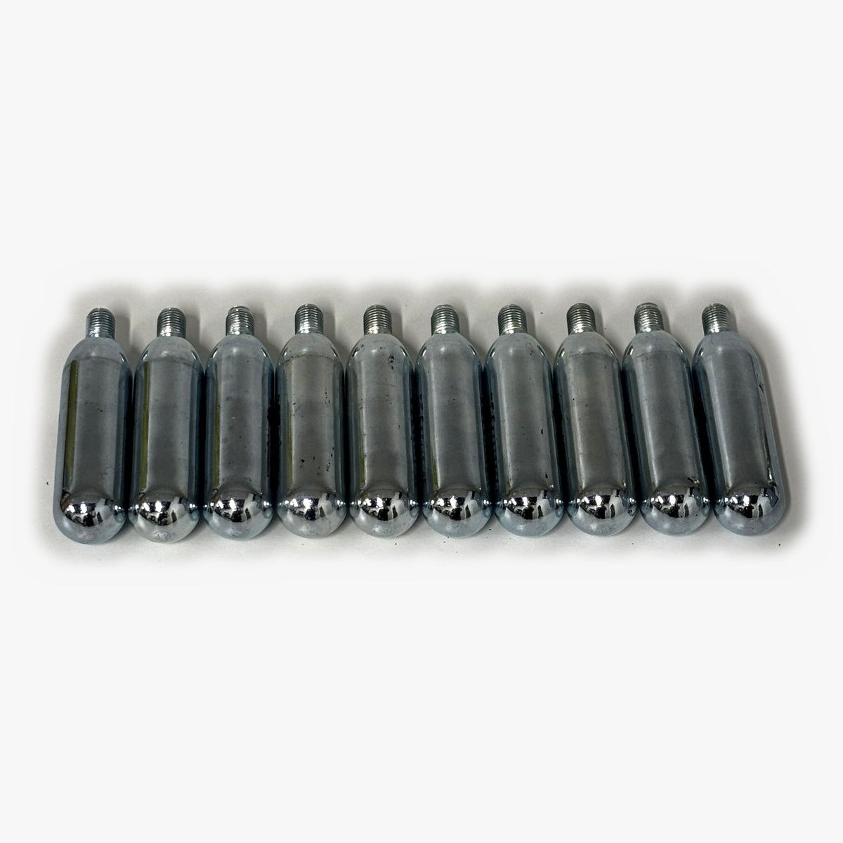 Top-down view of ten 16g CO2 bulbs with threaded necks, one bulb per 2L Mini Keg